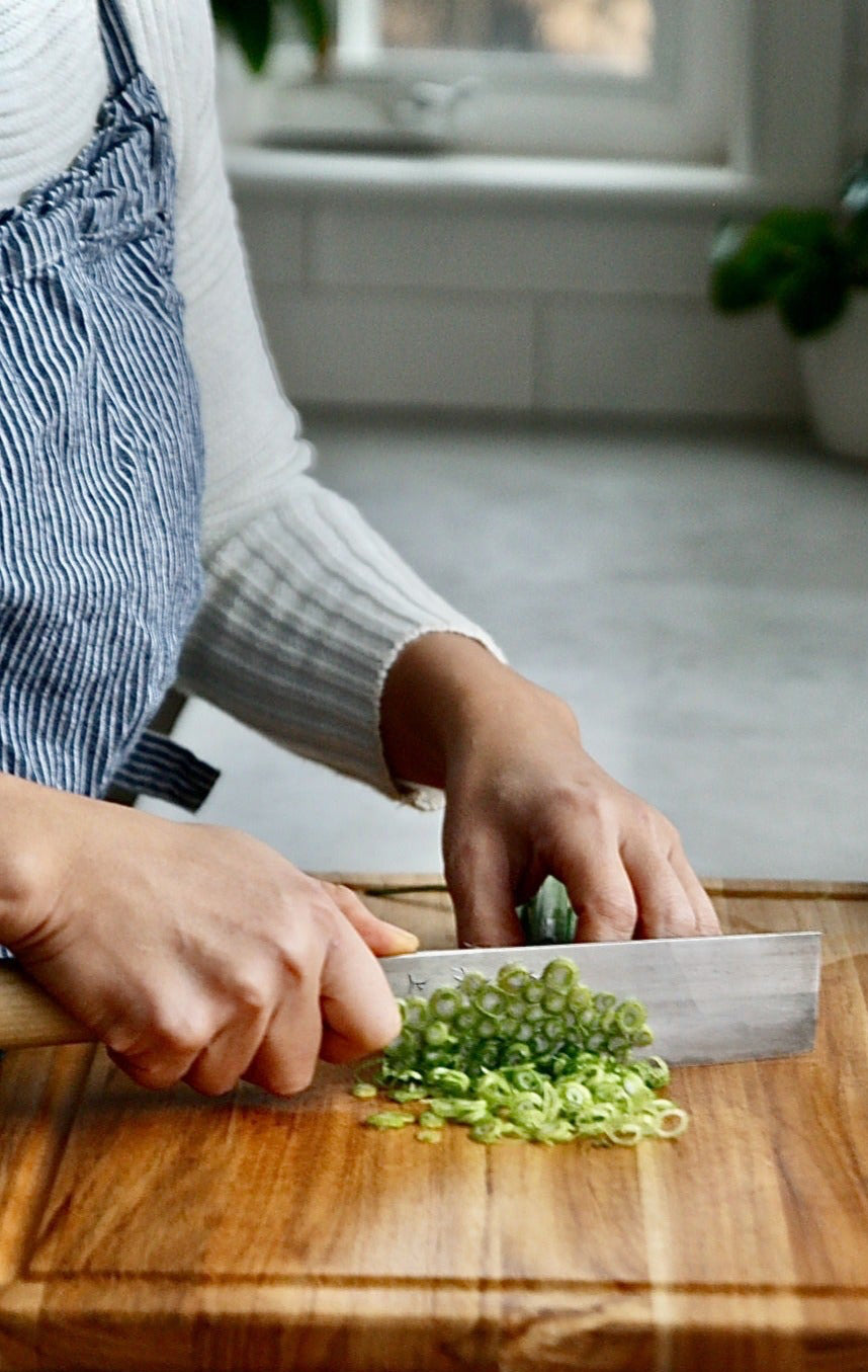 Aya chopping up green onions